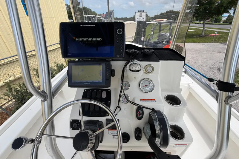 Slide: The Image of 2017 Mako 21 LTS boat dashboard with Humminbird and Garmin navigation systems. - 11