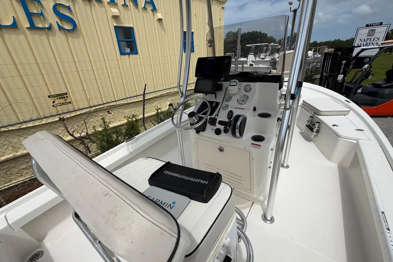 Slide: The Image of 2017 Mako 21 LTS boat interior with steering console and navigation equipment. - 12