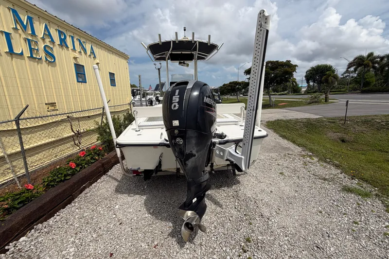 Slide: The Image of 2017 Mako 21 LTS boat with Mercury engine at marina, under cloudy sky. - 3