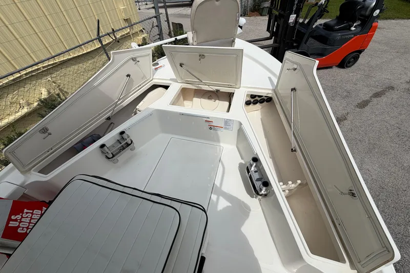 Slide: The Image of 2017 Mako 21 LTS boat with open storage compartments and visible equipment. - 7