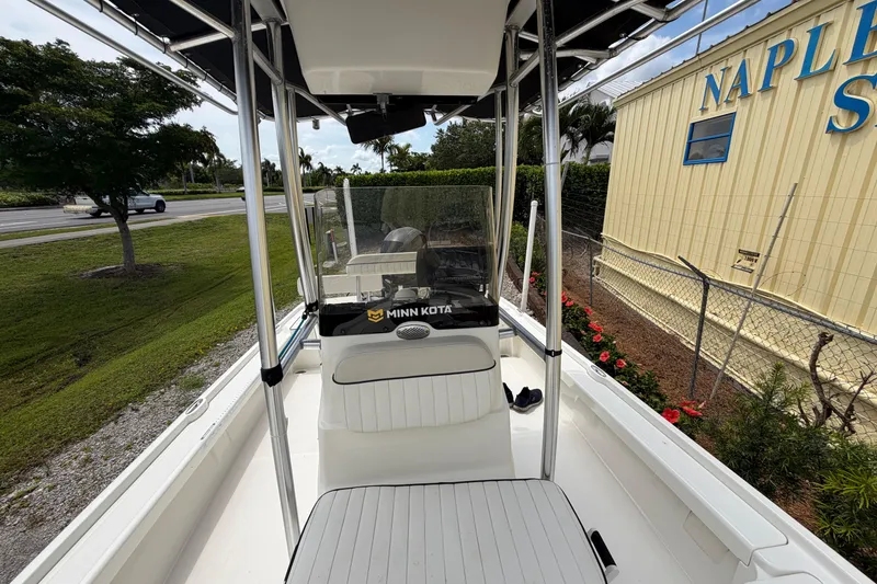 Slide: The Image of 2017 Mako 21 LTS boat with Minn Kota motor, parked near Naples sign. - 9