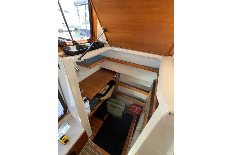 Slide: The Image of Interior storage area of a 2017 Ranger Tugs R-27 boat with wooden accents. - 18