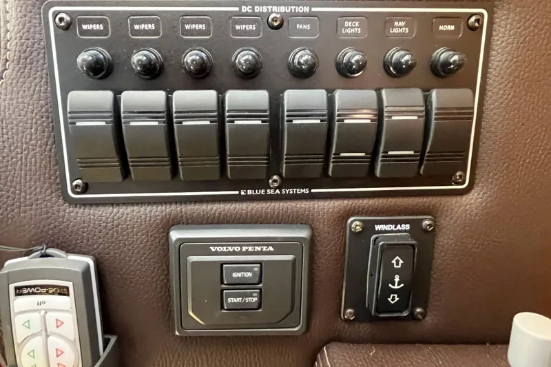Slide: The Image of Control panel of a 2017 Ranger Tugs R-27 boat with switches and ignition. - 28