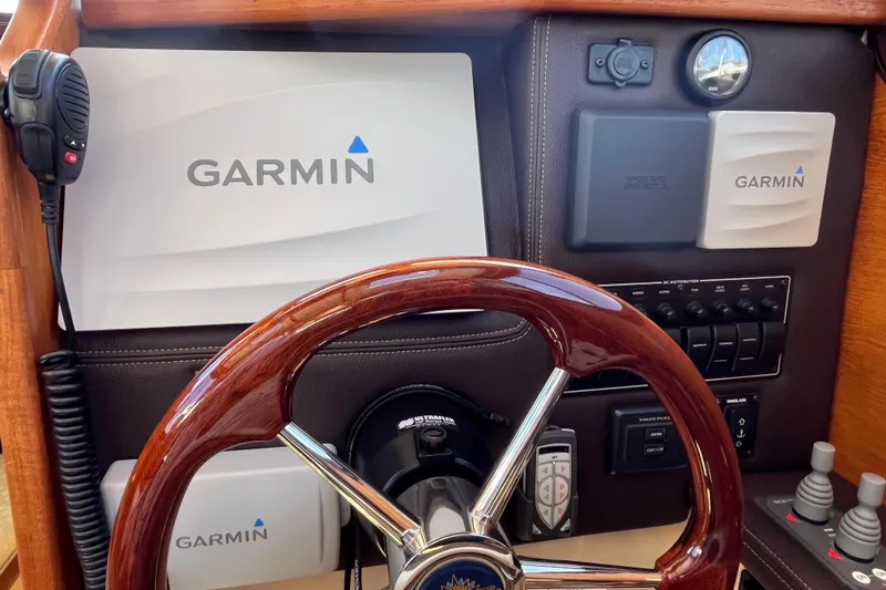 Slide: The Image of Steering wheel and Garmin navigation system on 2017 Ranger Tugs R-27 boat dashboard. - 29