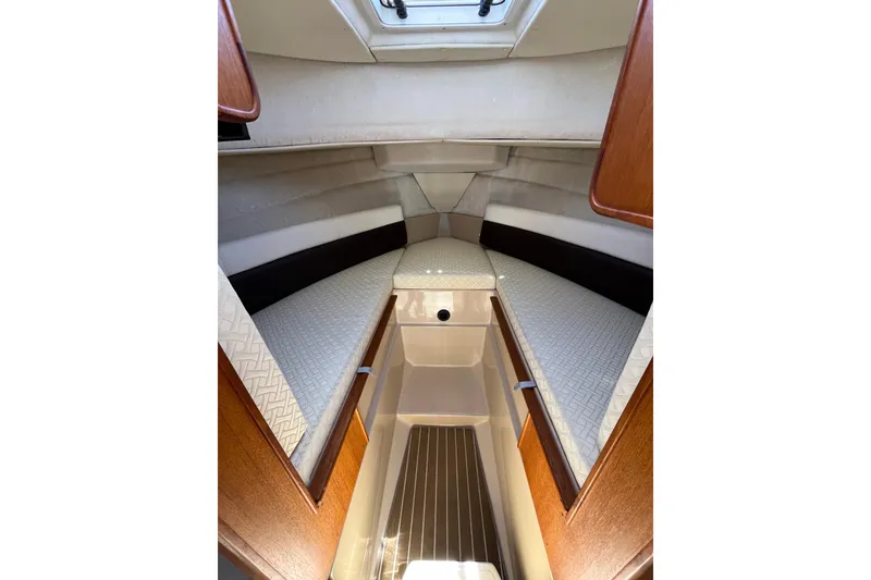 Slide: The Image of 2017 Ranger Tugs R-27 cabin interior with cozy sleeping area and wooden accents. - 33