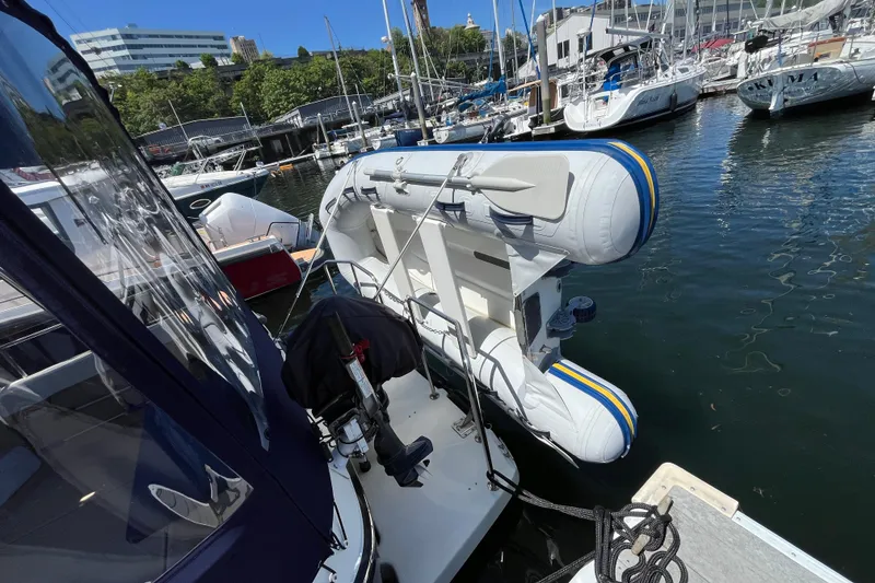 Slide: The Image of 2017 Ranger Tugs R-27 with inflatable dinghy docked at a marina. - 8
