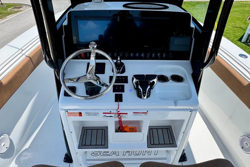 Slide: The Image of 2024 Sea Hunt Gamefish 27 Coffin Box helm with steering wheel and controls. - 10