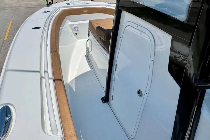 Slide: The Image of 2024 Sea Hunt Gamefish 27 Coffin Box boat interior with sleek design and cushioned seating. - 11