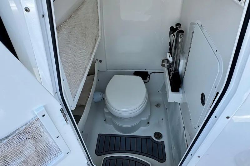 Slide: The Image of 2024 Sea Hunt Gamefish 27 Coffin Box boat interior with compact marine toilet. - 12