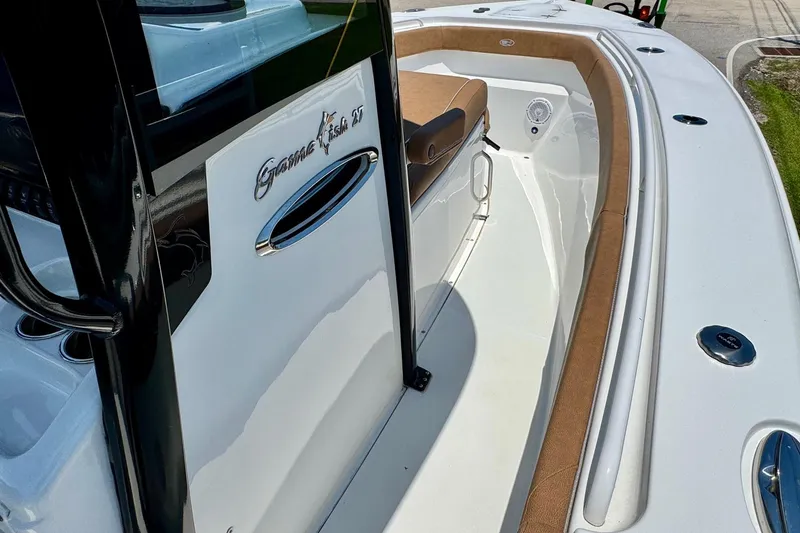 Slide: The Image of 2024 Sea Hunt Gamefish 27 Coffin Box boat interior with seating and sleek design. - 14