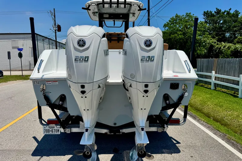 Slide: The Image of 2024 Sea Hunt Gamefish 27 Coffin Box with twin Yamaha 200 engines on a sunny street. - 3