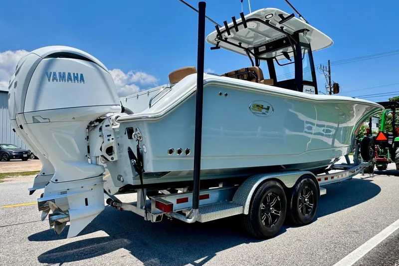 Slide: The Image of 2024 Sea Hunt Gamefish 27 Coffin Box boat on trailer with Yamaha engine. - 4