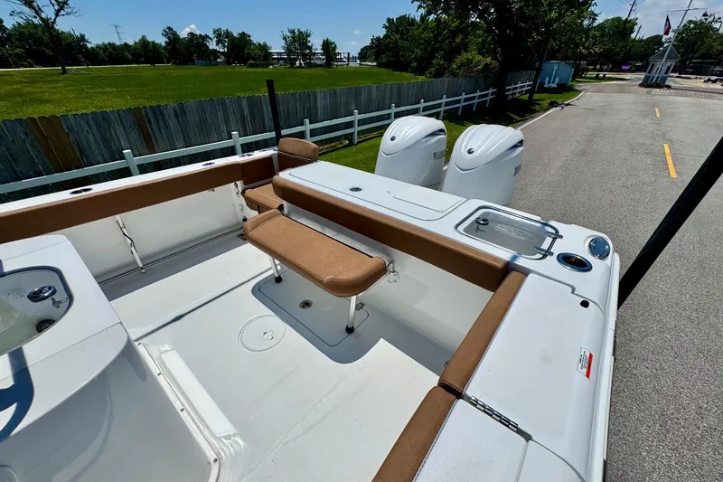 Slide: The Image of 2024 Sea Hunt Gamefish 27 Coffin Box boat with dual engines and seating area. - 7