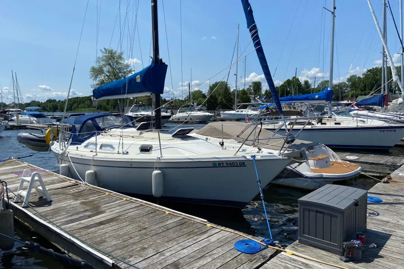 The Image of 1987 Ericson 28/2 sailboat docked at a marina on a sunny day. - 0