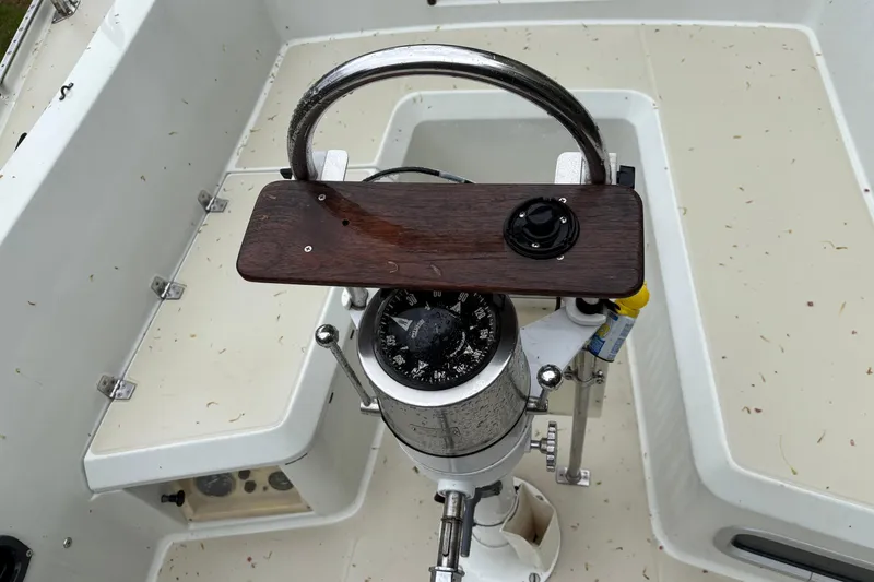 Slide: The Image of Steering wheel and compass of a 1987 Ericson 28/2 sailboat cockpit. - 11