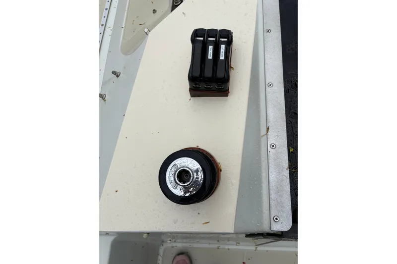 Slide: The Image of Deck hardware on a 1987 Ericson 28/2 sailboat, featuring a winch and rope clutches. - 12