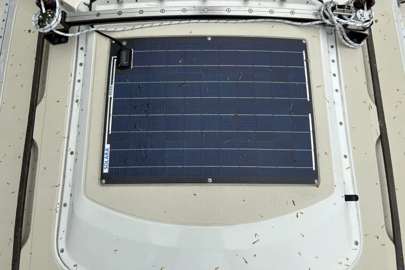 Slide: The Image of Solar panel on 1987 Ericson 28/2 sailboat deck, surrounded by scattered debris. - 22