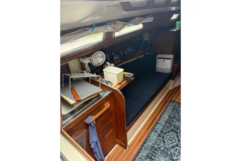 Slide: The Image of Interior of 1987 Ericson 28/2 sailboat with wooden cabinetry and seating area. - 28