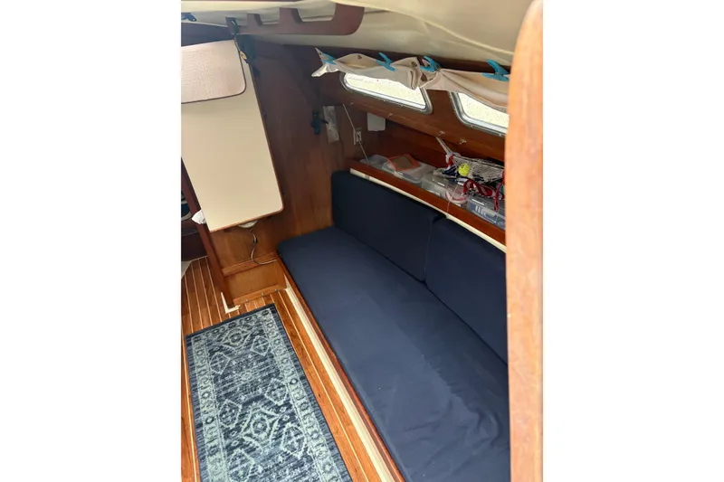 Slide: The Image of Interior of 1987 Ericson 28/2 sailboat with blue seating and wooden accents. - 29
