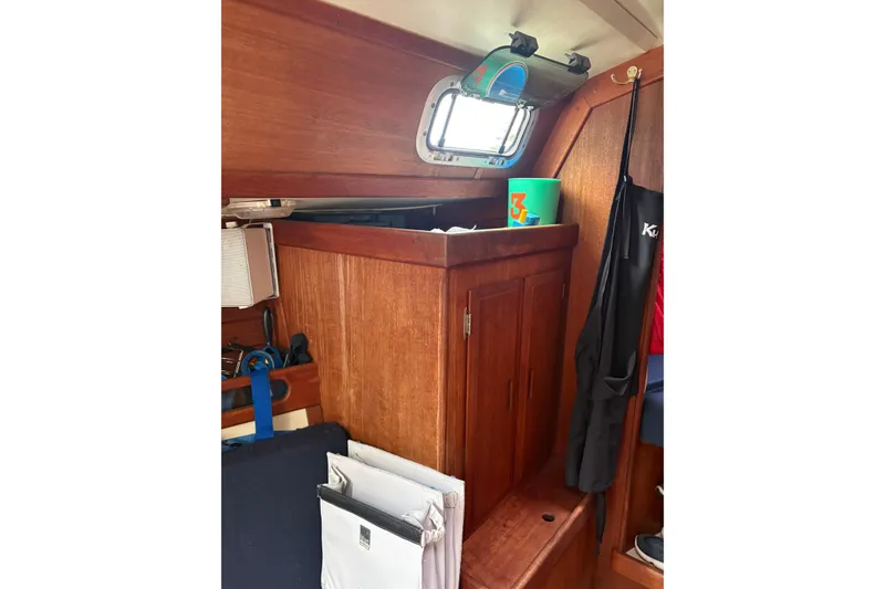 Slide: The Image of Interior of 1987 Ericson 28/2 sailboat with wooden cabinetry and nautical equipment. - 32