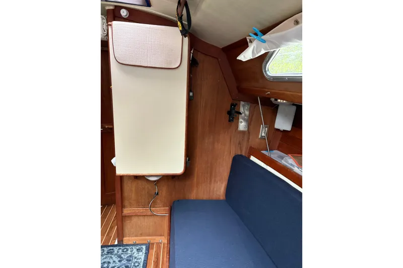 Slide: The Image of Interior of 1987 Ericson 28/2 sailboat with wooden paneling and blue seating. - 36