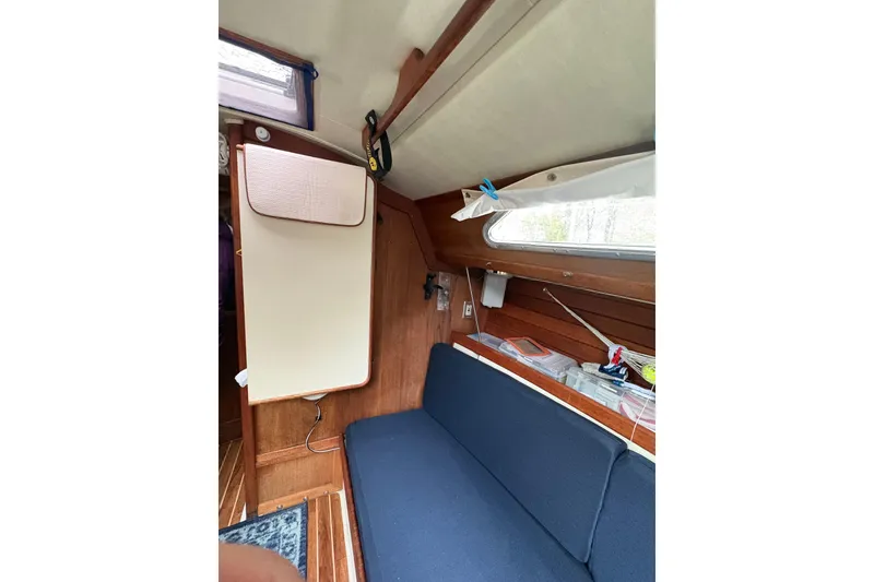 Slide: The Image of Interior of 1987 Ericson 28/2 sailboat with blue seating and wooden paneling. - 37