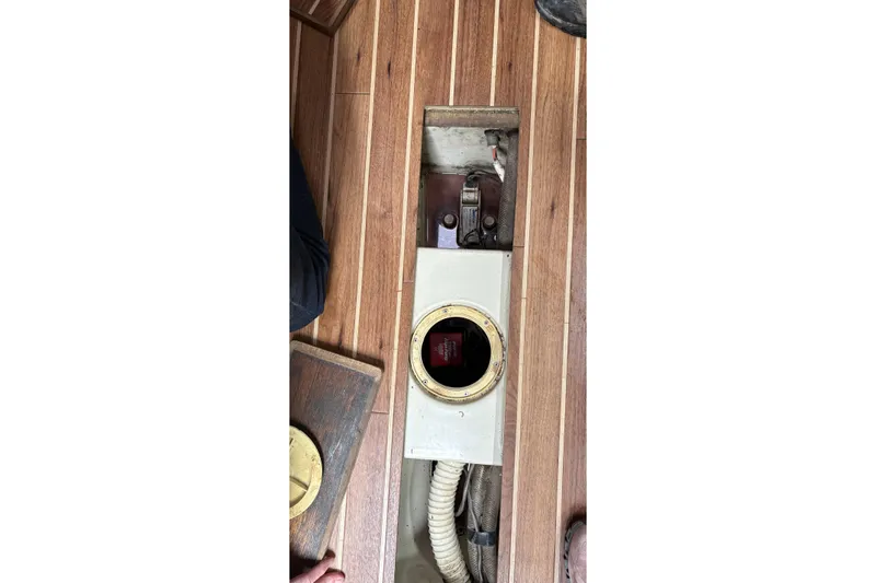 Slide: The Image of 1987 Ericson 28/2 sailboat interior showing floor compartment and mechanical components. - 42