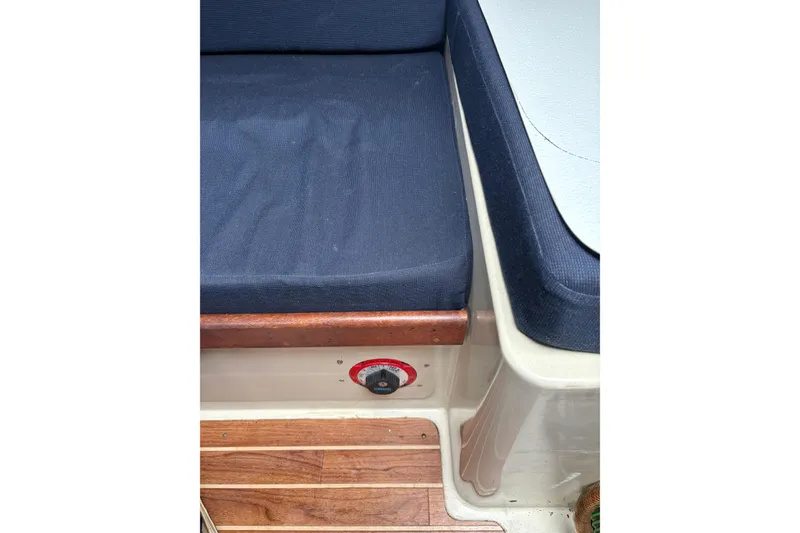 Slide: The Image of Interior seating of 1987 Ericson 28/2 sailboat with blue cushions and wooden accents. - 44