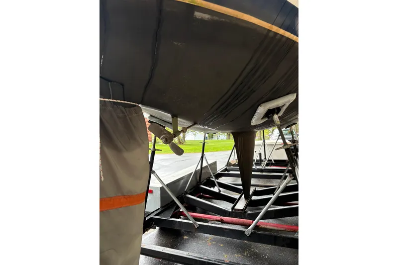 Slide: The Image of 1987 Ericson 28/2 sailboat on trailer, showing hull and propeller. - 6
