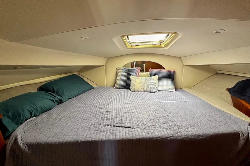 Slide: The Image of Cozy cabin bedroom in 2001 Silverton 330 Sport Bridge yacht with skylight and pillows. - 10