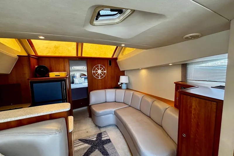 Slide: The Image of Interior of 2001 Silverton 330 Sport Bridge yacht with modern seating and wood accents. - 6