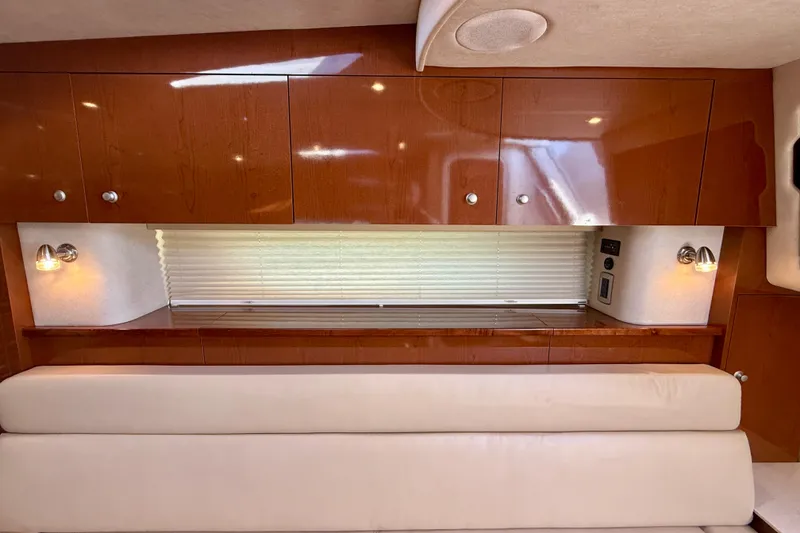 Slide: The Image of Luxurious interior of 2009 Sea Ray Sundancer 350 with wooden cabinets and plush seating. - 13