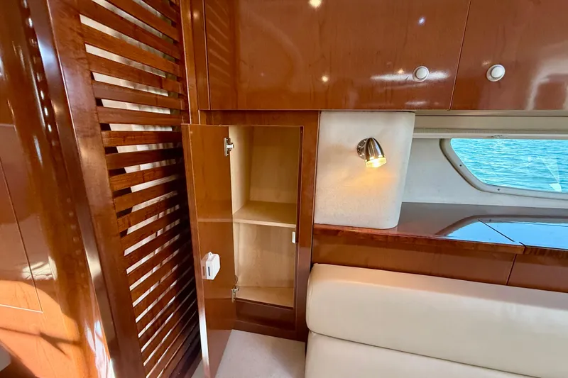 Slide: The Image of Interior of 2009 Sea Ray Sundancer 350 yacht with wooden cabinetry and open storage. - 18