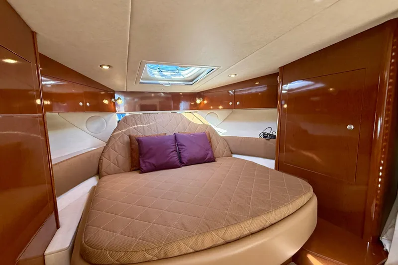 Slide: The Image of Luxurious cabin interior of 2009 Sea Ray Sundancer 350 with plush bedding and wood finish. - 19