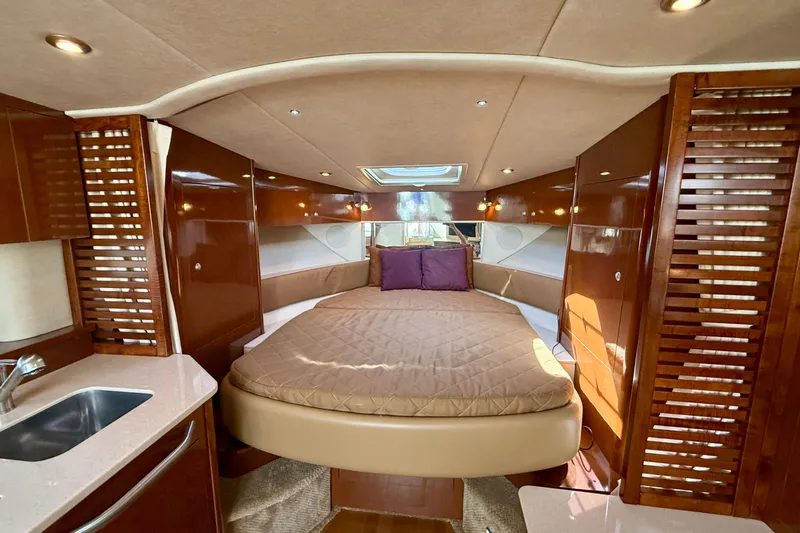Slide: The Image of Luxurious interior of 2009 Sea Ray Sundancer 350 yacht with cozy bed and elegant wood finishes. - 21