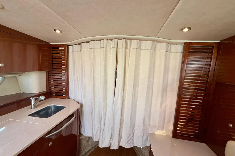 Slide: The Image of Interior of 2009 Sea Ray Sundancer 350 yacht with kitchenette and curtain divider. - 23