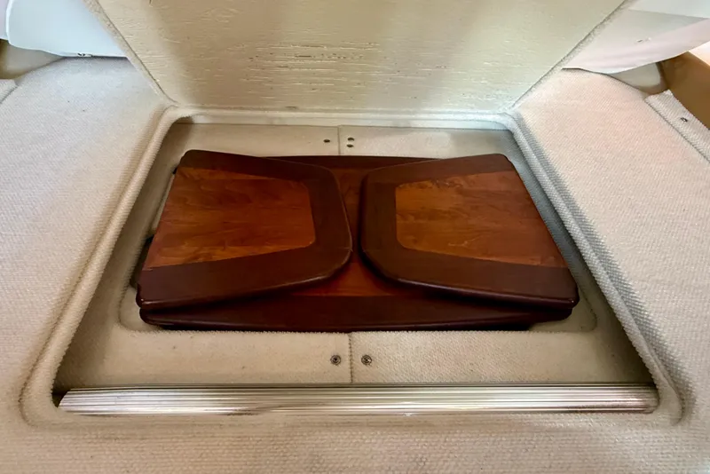 Slide: The Image of 2009 Sea Ray Sundancer 350 interior with wooden table and carpeted surroundings. - 24