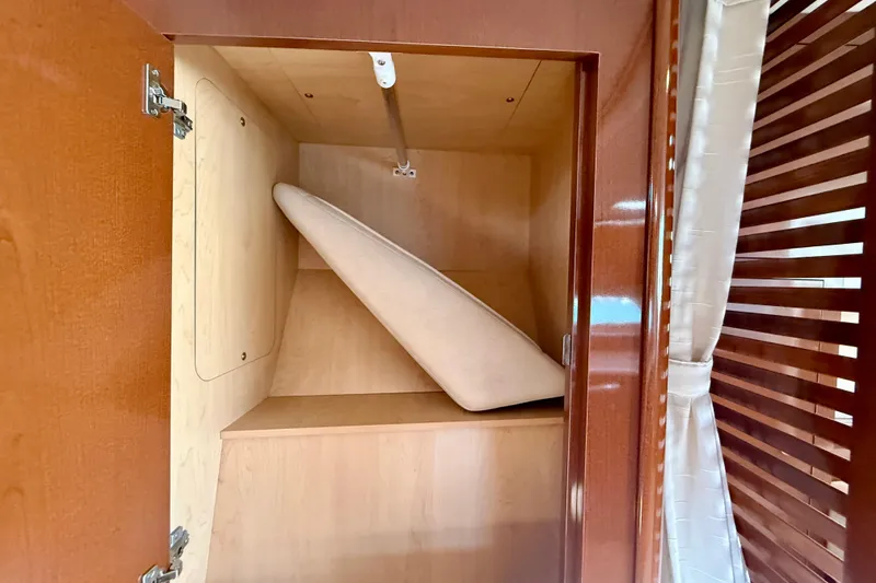 Slide: The Image of Open wooden cabinet with a cushion inside, Sea Ray Sundancer 350, 2009 model. - 25