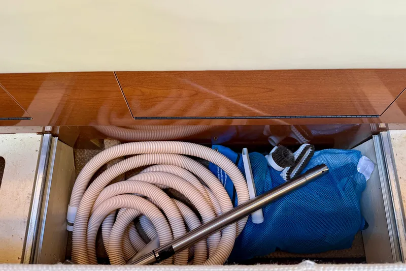 Slide: The Image of Storage compartment on a 2009 Sea Ray Sundancer 350 with hoses and cleaning tools. - 27