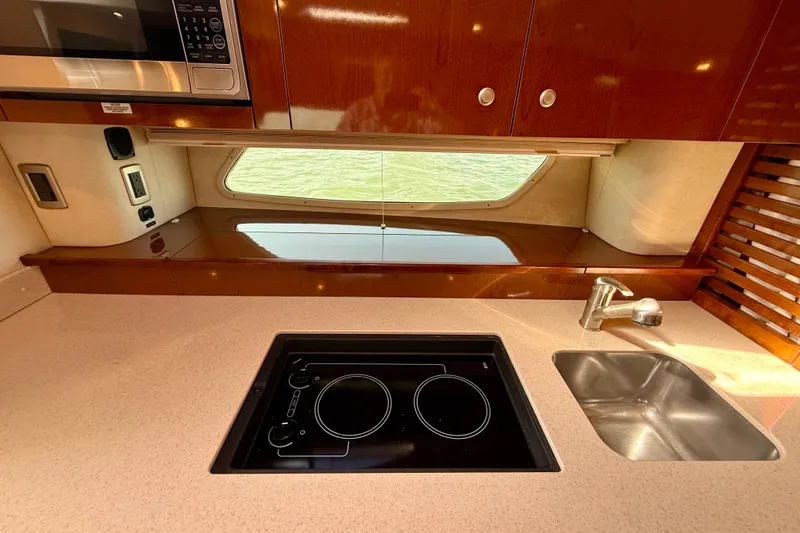 Slide: The Image of 2009 Sea Ray Sundancer 350 yacht kitchen with stove, sink, and microwave. - 29