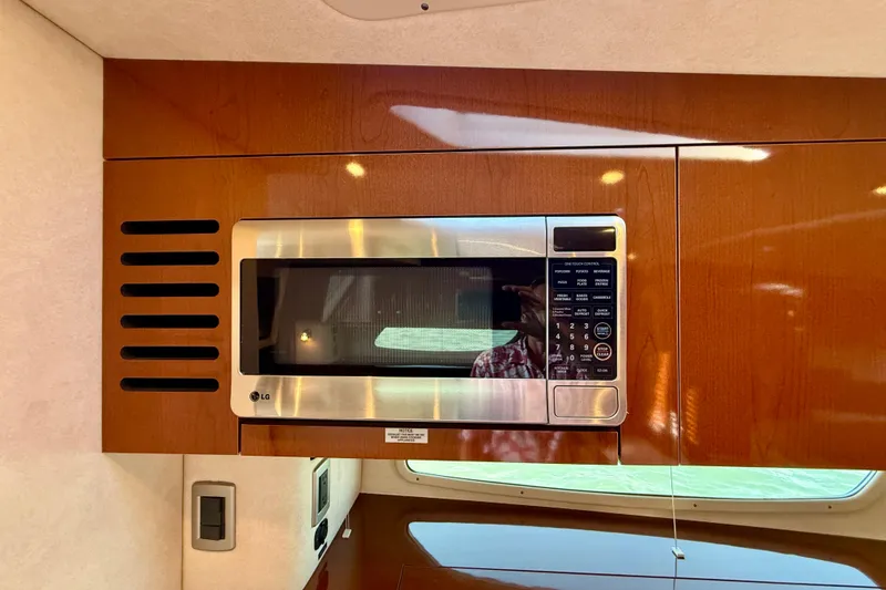 Slide: The Image of Microwave in 2009 Sea Ray Sundancer 350 yacht kitchen with wooden cabinetry. - 30
