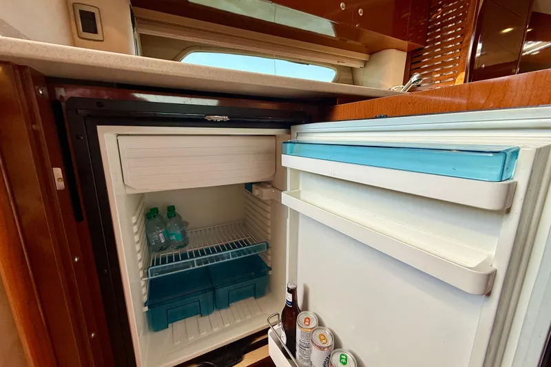 Slide: The Image of Open mini fridge inside 2009 Sea Ray Sundancer 350 yacht, stocked with drinks. - 32