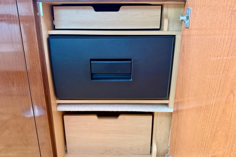 Slide: The Image of Wooden cabinet with drawers inside a 2009 Sea Ray Sundancer 350 boat. - 33