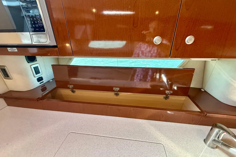 Slide: The Image of 2009 Sea Ray Sundancer 350 interior with wooden cabinetry and built-in microwave. - 35