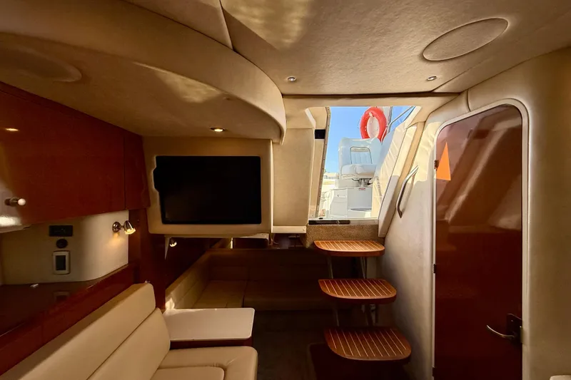 Slide: The Image of Luxurious interior of 2009 Sea Ray Sundancer 350 yacht with elegant seating and wooden accents. - 38
