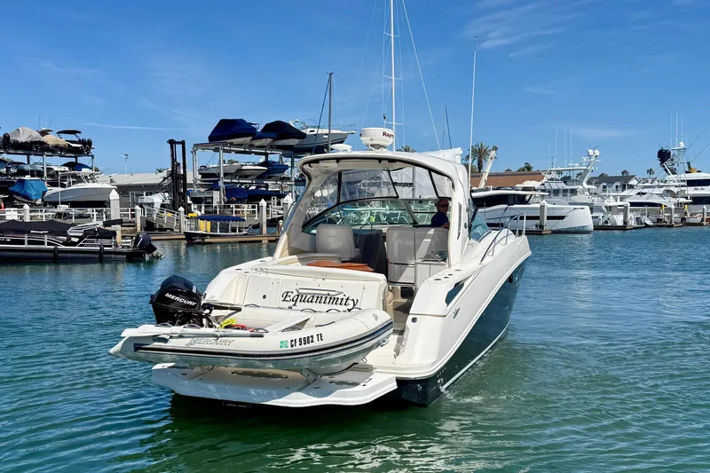 Slide: The Image of 2009 Sea Ray Sundancer 350 yacht docked in a marina, featuring a Mercury engine. - 4