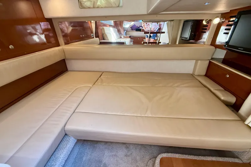 Slide: The Image of Interior of 2009 Sea Ray Sundancer 350 with beige leather seating and wooden accents. - 41