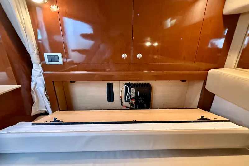Slide: The Image of 2009 Sea Ray Sundancer 350 interior with open cabinet revealing electrical components. - 42