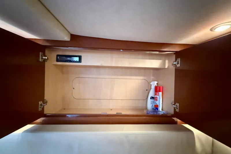 Slide: The Image of Interior storage cabinet on a 2009 Sea Ray Sundancer 350 yacht, featuring cleaning supplies. - 43
