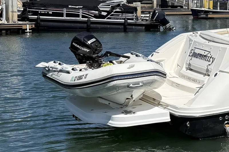 Slide: The Image of 2009 Sea Ray Sundancer 350 with dinghy and Mercury outboard motor at marina. - 5
